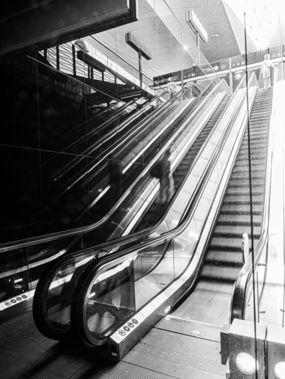 picture of the mirror image of an escalator on a train station