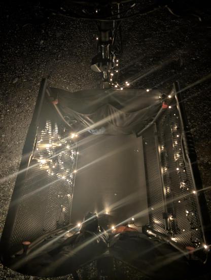 Black cargo bike at night with LEDs mounted in the inner side of the opened cargo box