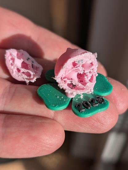 for the general description, read the other Alt-text. Here, the same figure is cut open with some organic looking structure in it and some empty space