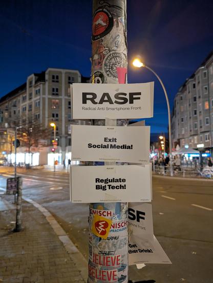 Berlin lamp post with guerilla stickers: 
RASF
Radical Anti Smartphone Front
Exit Social Media!
Regulate Big Tech!