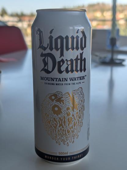 Can of "Liquid Death" "Murder your thirst" in the style of death metal band covers or so