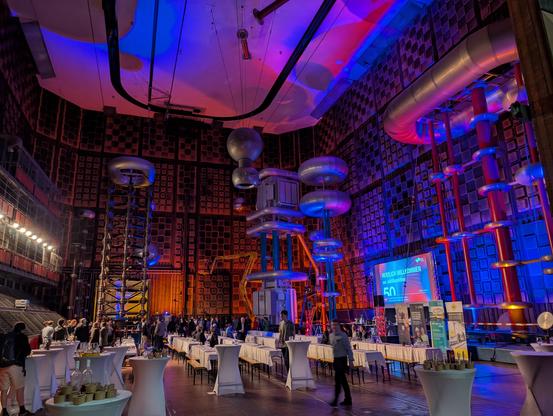 High voltage installation with colorful lights and guests