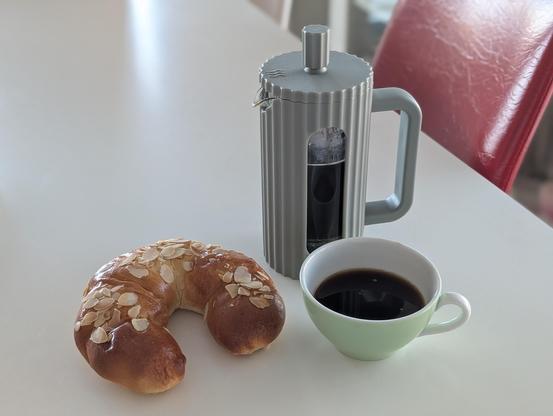 A Loffee french press, a cup of lupine coffee substitute together with a Nusskipferl waiting to be consumed by me 😉