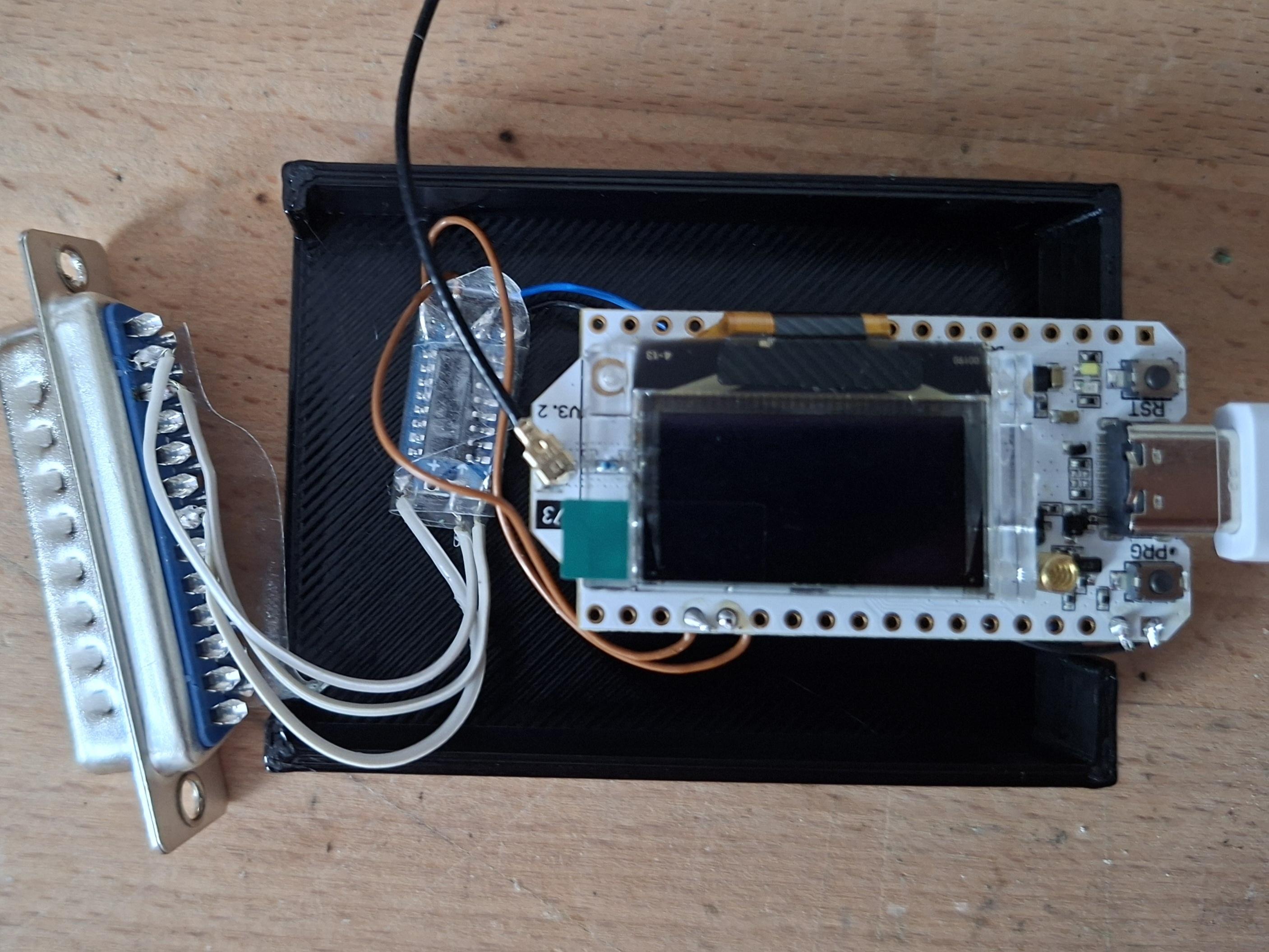 Heltec V3 LoRa module with a Max232 level shifter into a 25 pin D-Sub connector. All crammed into a 3d printed enclosure